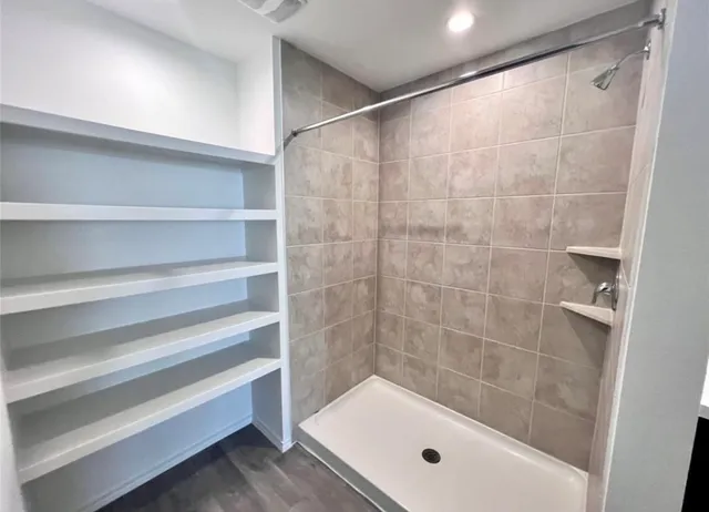 a bathroom with a bathtub and shower