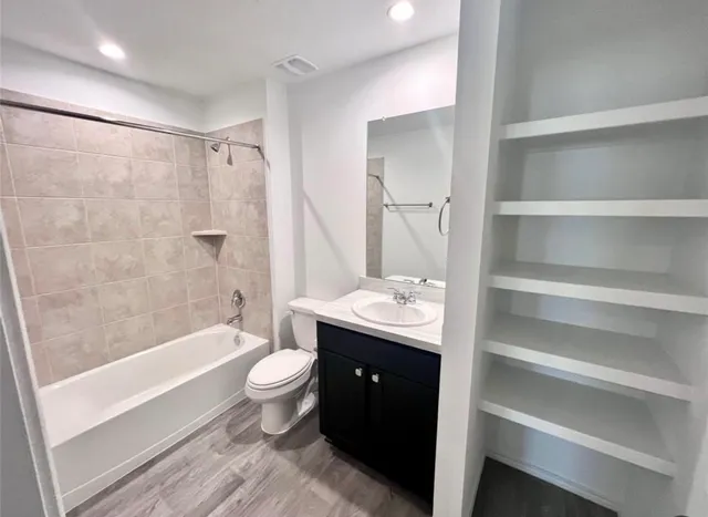 a bathroom with a double vanity sink toilet and shower