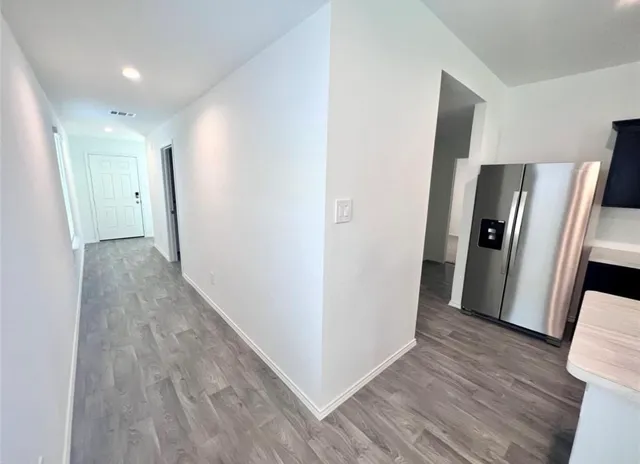 a view of hallway with wooden floor