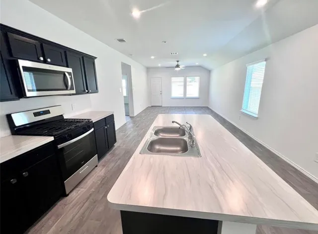 a kitchen with a sink and large window