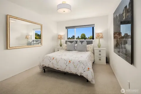 a bedroom with a bed and a painting on the wall