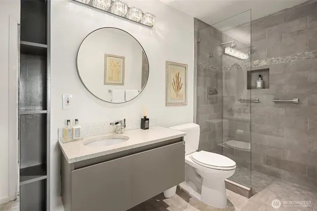 a bathroom with a toilet a sink and a mirror