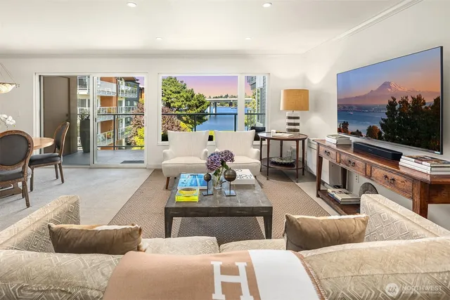 a living room with furniture and a floor to ceiling window