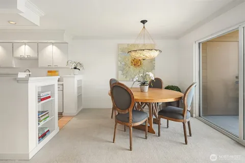 a view of a dining room with furniture and a chandelier