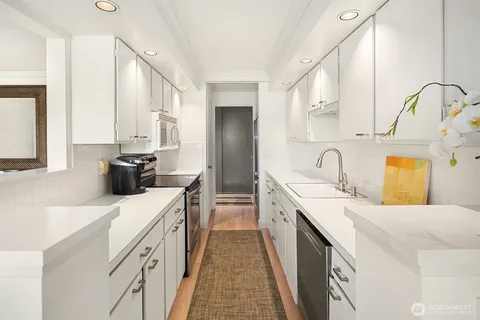 a kitchen with a sink stove and cabinets