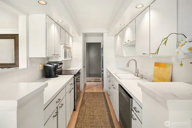 a kitchen with a sink stove and cabinets