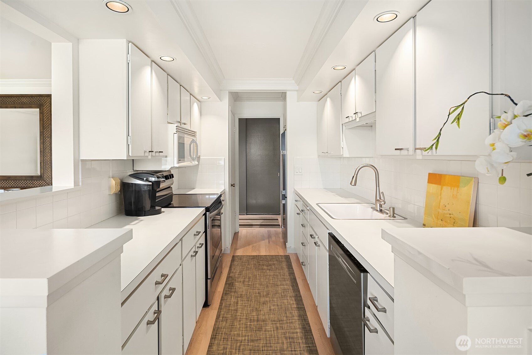 2500 Canterbury Lane East, Unit 302 Seattle, WA 98112 - Photo 9 of 33 a kitchen with a sink stove and cabinets