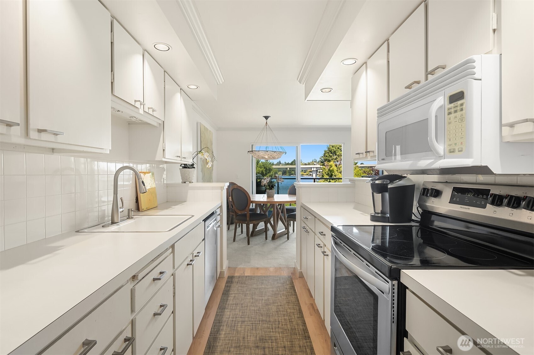 2500 Canterbury Lane East, Unit 302 Seattle, WA 98112 - Photo 10 of 33 a kitchen with a sink and a stove top oven