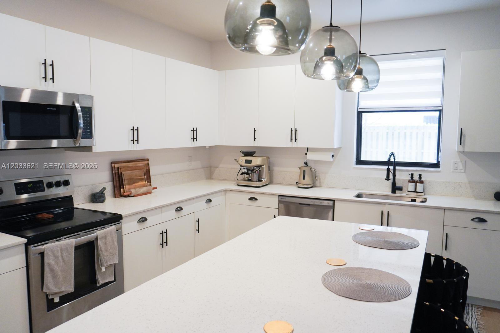 11942 Southwest 243rd Street Homestead, FL 33032 - Photo 11 of 50 a kitchen with a white cabinets and white appliances