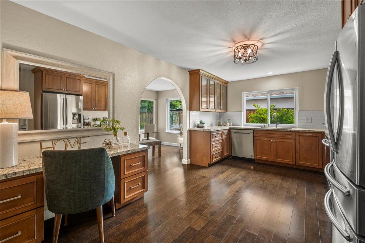 4118 Rosenbaum Avenue San Jose, CA 95136 - Photo 12 of 55 a kitchen with a table chairs refrigerator and cabinets