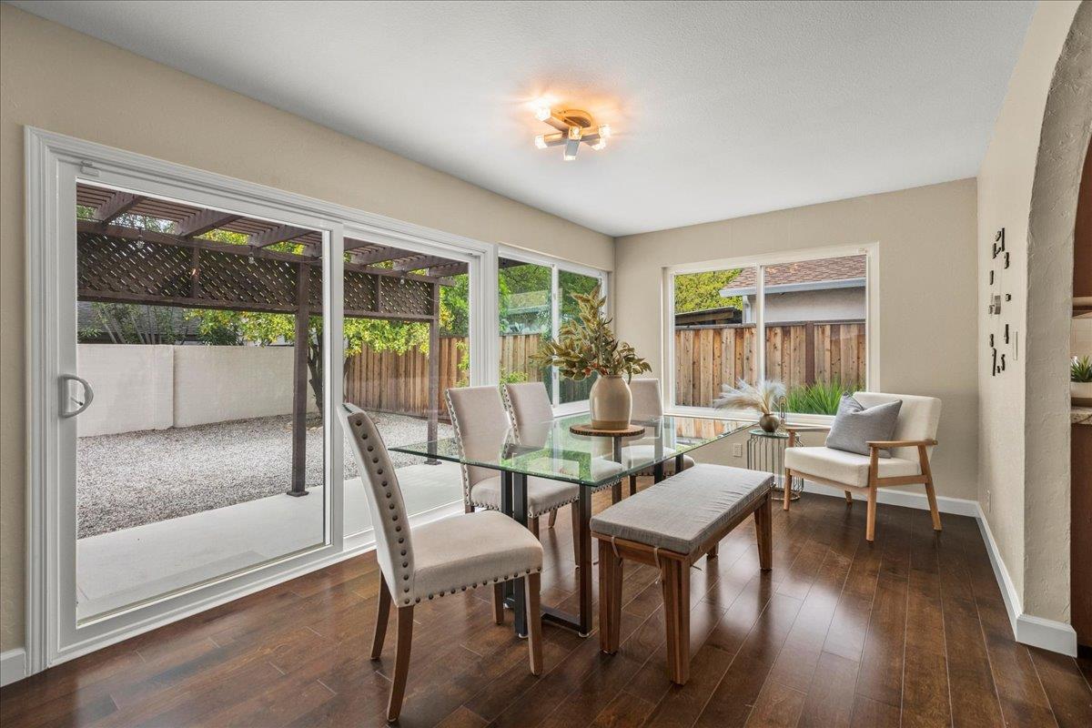 4118 Rosenbaum Avenue San Jose, CA 95136 - Photo 16 of 55 a view of a dining room with furniture large windows and wooden floor