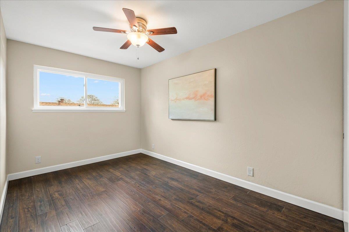 4118 Rosenbaum Avenue San Jose, CA 95136 - Photo 32 of 55 a view of an empty room with wooden floor and a ceiling fan