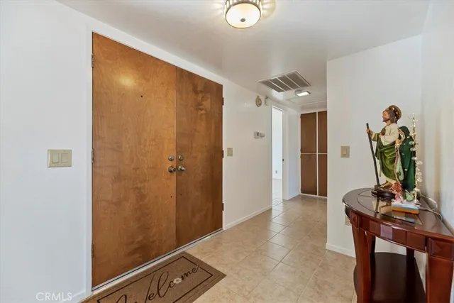 a dining room with furniture a chandelier and window