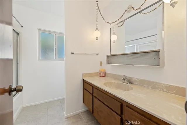 a view of a patio with couches and table and chairs with wooden floor and fence