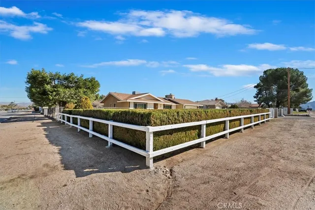 a aerial view of a house with a yard and sitting area
