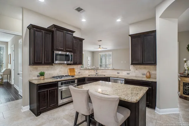 a kitchen that has a sink and a stove in it