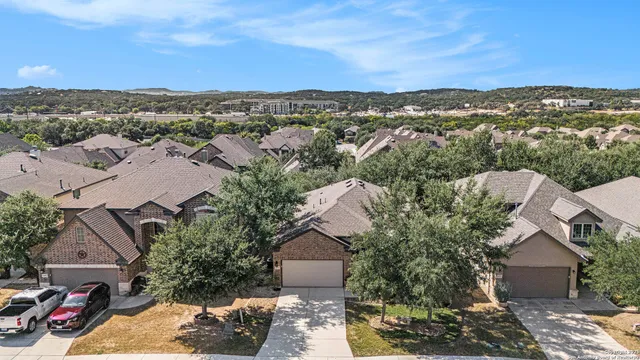 an aerial view of a house with a mountain