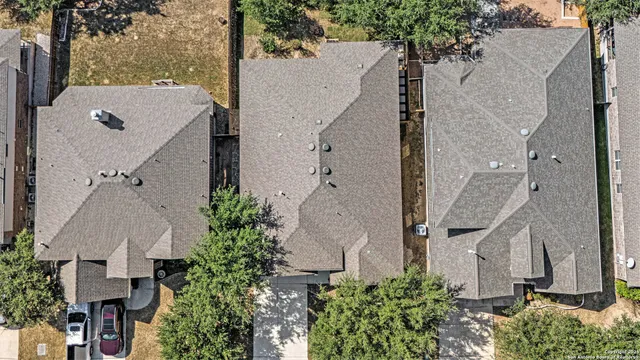 an aerial view of a house with a yard and plants