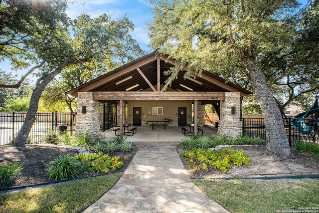 a front view of house with a garden and patio