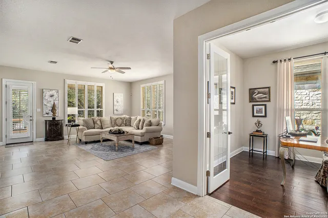 a living room with furniture and wooden floor