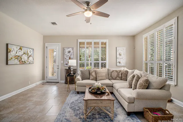a living room with furniture and a large window