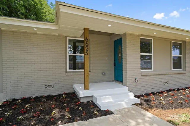 a view of a house with a door and wooden floor