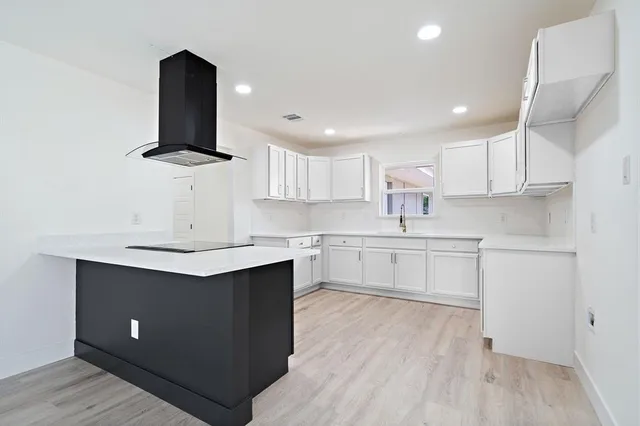 a kitchen with stainless steel appliances a sink stove and cabinets