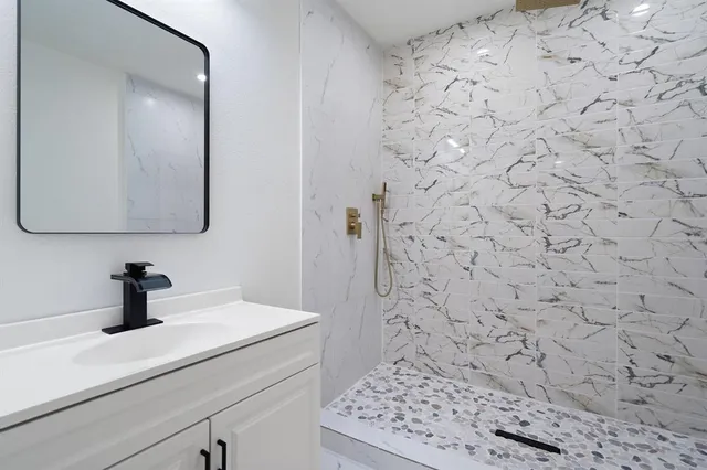 a bedroom with a bed window and a flat screen tv