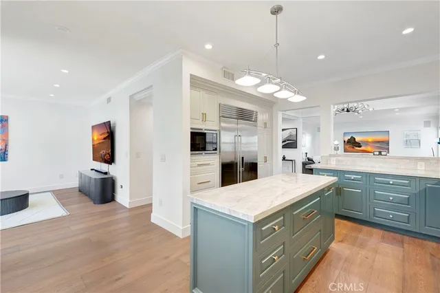 a kitchen with stainless steel appliances granite countertop a sink a stove and a refrigerator