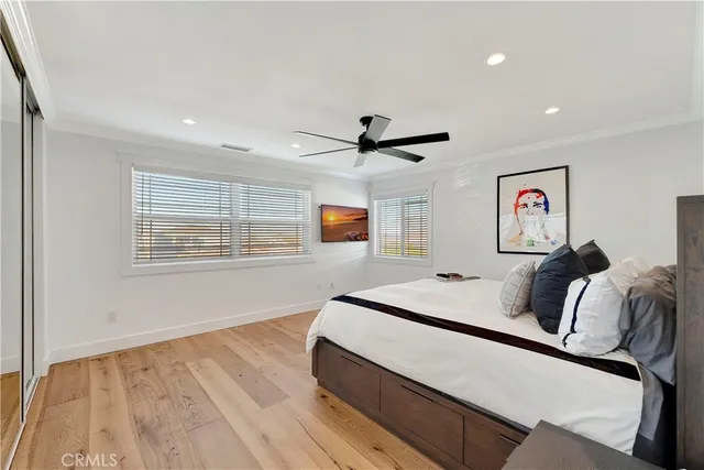 a bed room with a bed and a ceiling fan