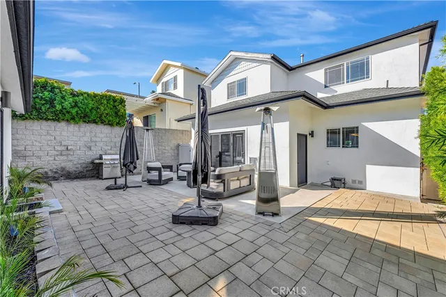 a view of a chairs and table in backyard of the house