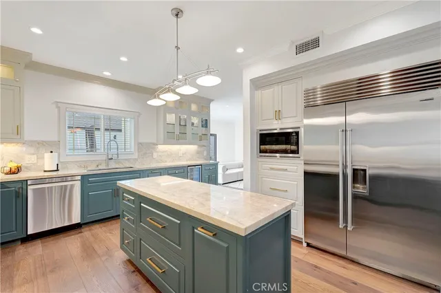 a kitchen with stainless steel appliances granite countertop a sink and stove top oven