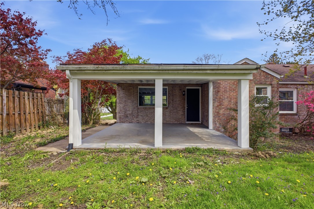 3232 Bears Den Road Youngstown, OH 44511 - Photo 31 of 38 Brick exterior featuring a covered patio with concrete flooring and white support columns