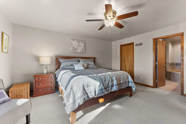 a bedroom with a bed and a painting on the wall