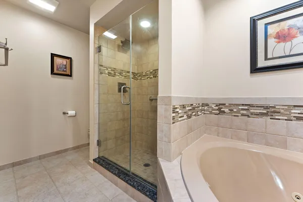 a bathroom with a bathtub and a shower