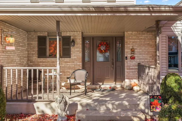 a front view of a house with outdoor seating