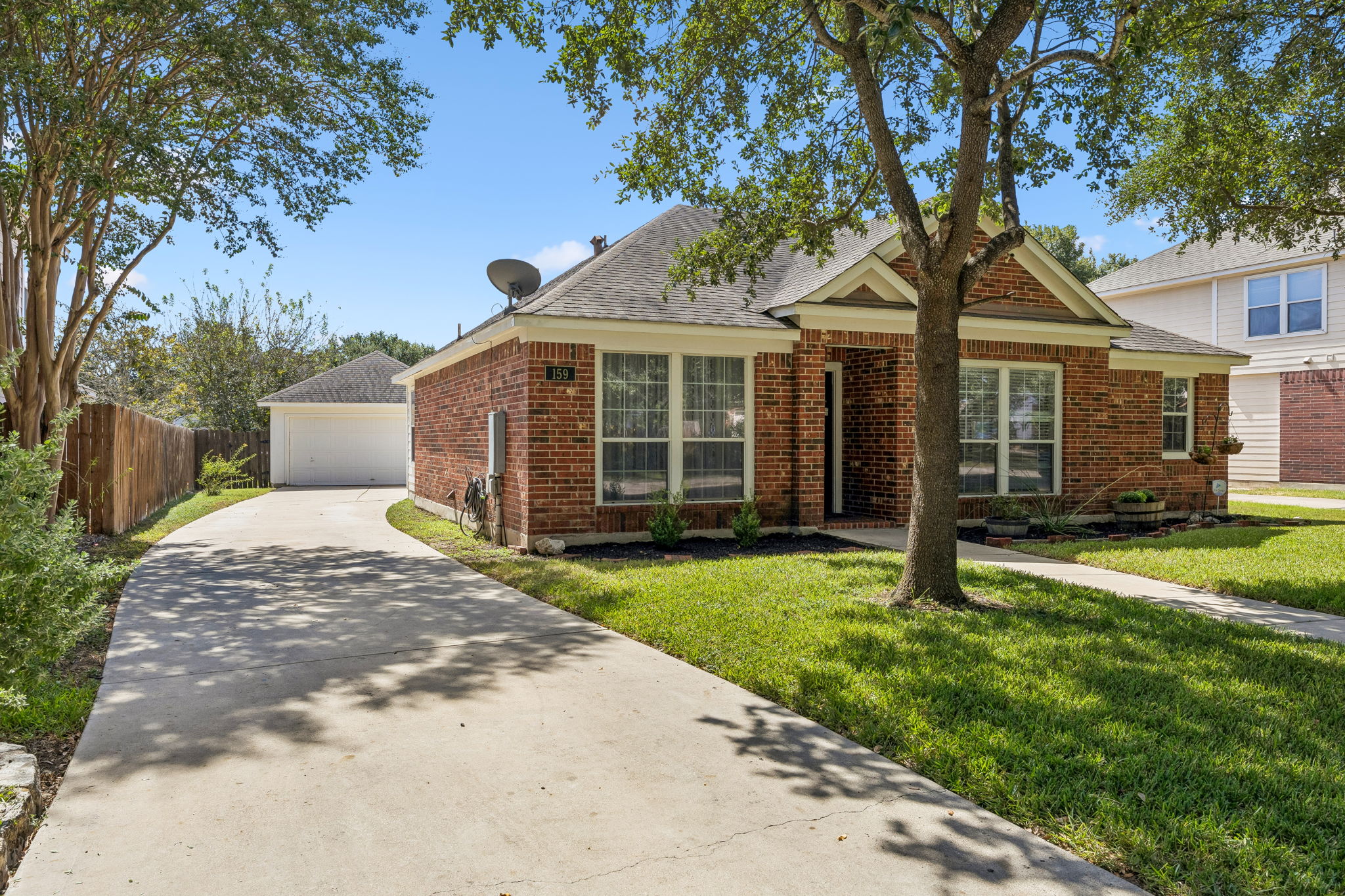 159 Invierno Street Kyle, TX 78640 - Photo 8 of 40 Set among mature trees in Kyle’s established Four Seasons Farm, this beautifully maintained single-story Perry home offers a peaceful neighborhood setting.