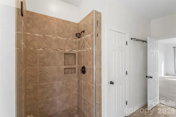a bathroom with a shower and a glass door