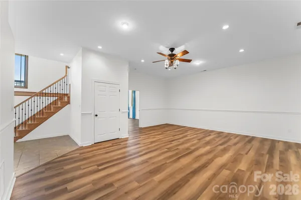 a view of an empty room and wooden floor