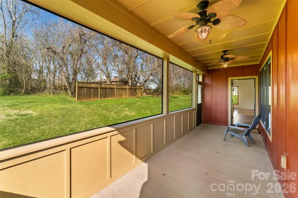 a view of a porch with furniture and a yard