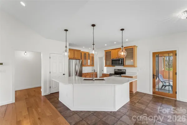 a kitchen with stainless steel appliances granite countertop a sink and a refrigerator