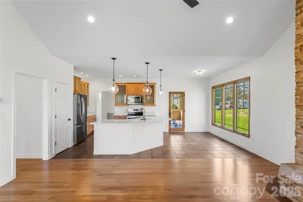 a kitchen with a refrigerator and a stove top oven