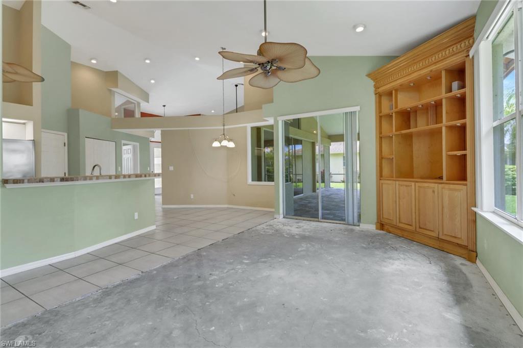 481 Raven Way Naples, FL 34110 - Photo 11 of 30 an empty room with entrance and windows
