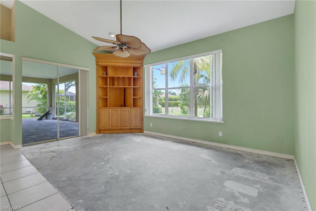 481 Raven Way Naples, FL 34110 - Photo 12 of 30 a big room with windows and chandelier