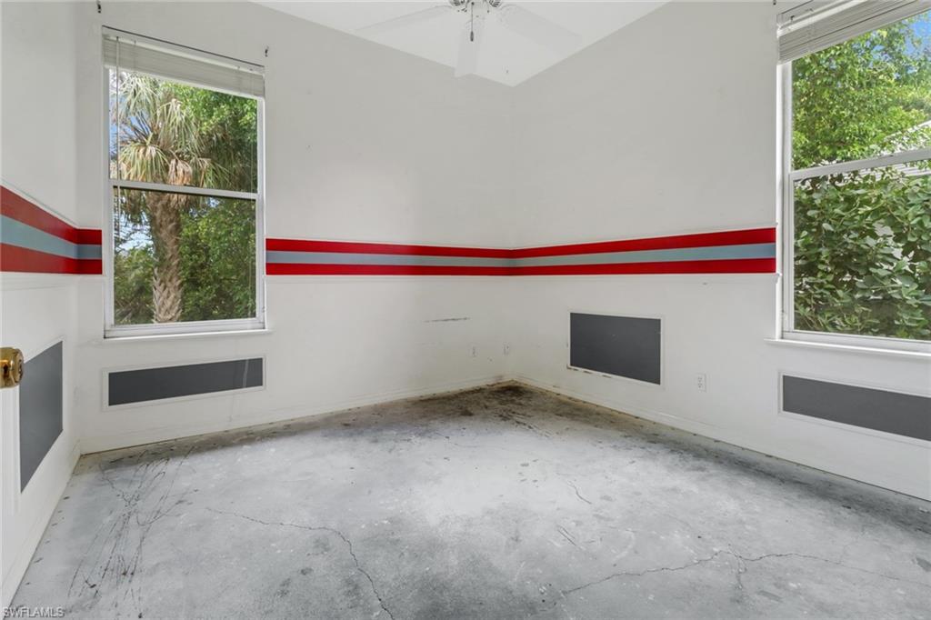 481 Raven Way Naples, FL 34110 - Photo 17 of 30 a view of an empty room with a window