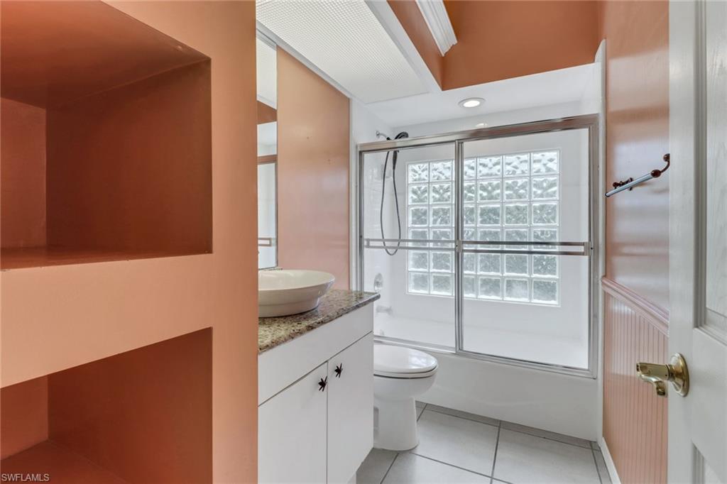 481 Raven Way Naples, FL 34110 - Photo 22 of 30 a bathroom with a granite countertop sink and a mirror