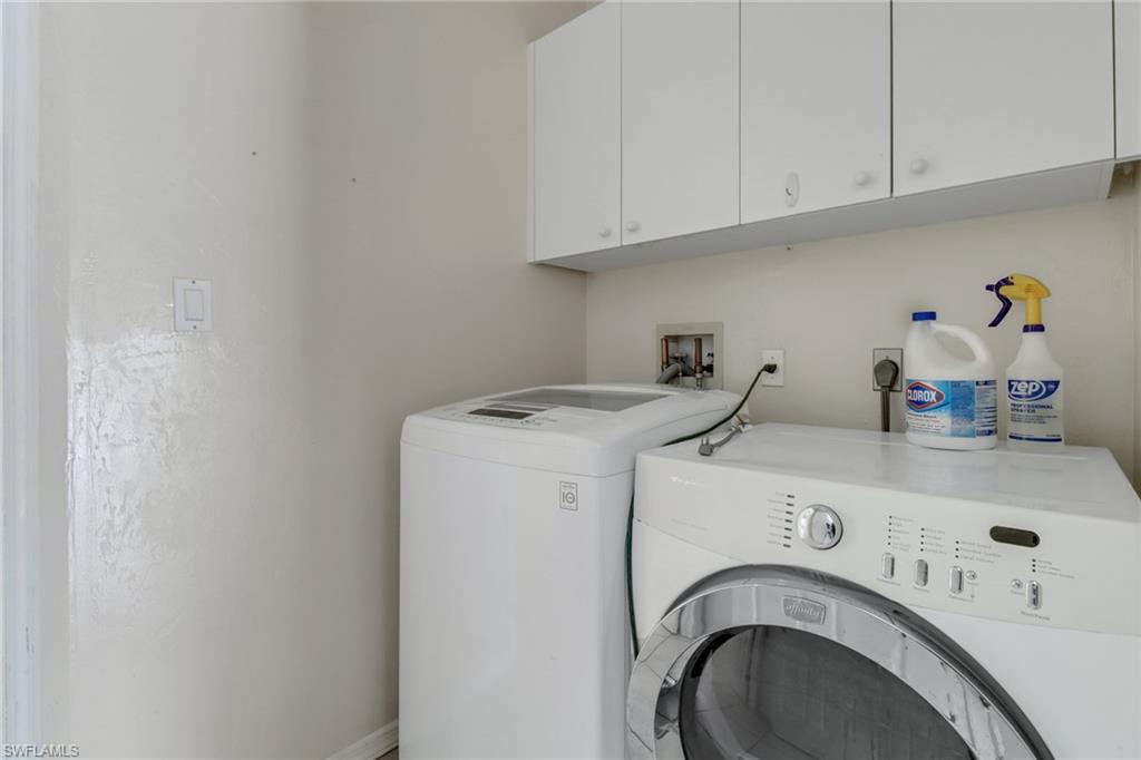 481 Raven Way Naples, FL 34110 - Photo 23 of 30 a utility room with dryer and washer
