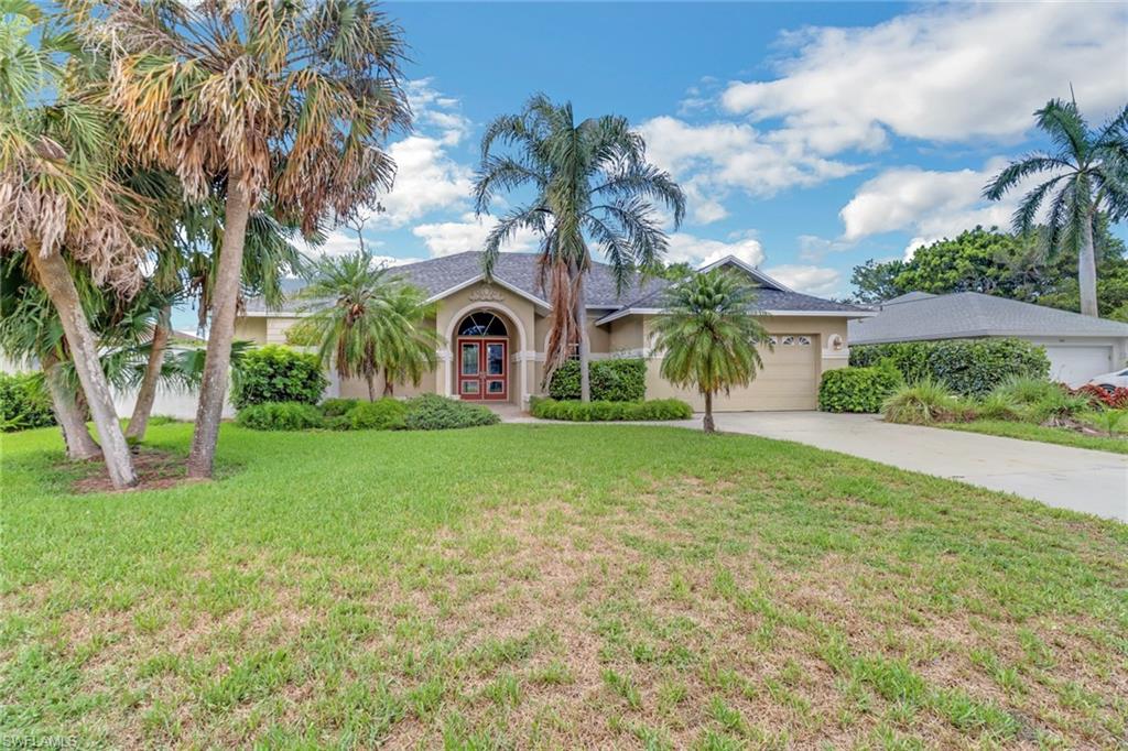481 Raven Way Naples, FL 34110 - Photo 29 of 30 a front view of a house with garden