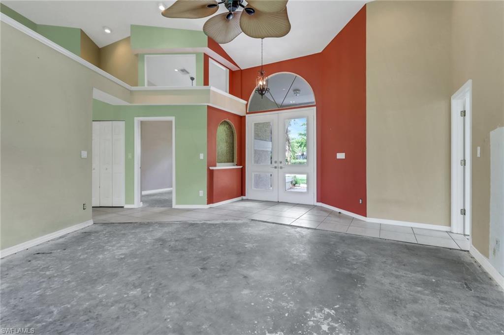 481 Raven Way Naples, FL 34110 - Photo 3 of 30 an empty room with fan and windows