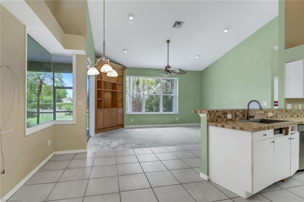 481 Raven Way Naples, FL 34110 - Photo 7 of 30 a view of a kitchen with a sink and window
